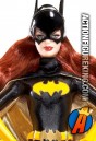 A detailed view of this Pink Label Barbie as Batgirl dressed figure.