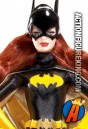A detailed view of this Pink Label Barbie as Batgirl dressed figure.